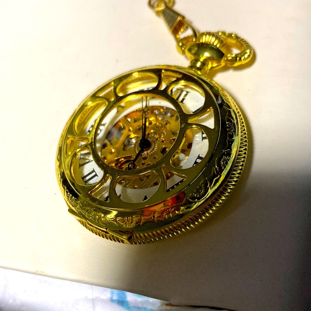 working pocket watch.  Gold tone.  With long chain. Beautiful piece.  Bme2476